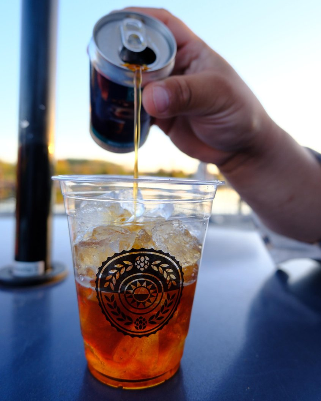 Person pouring beer into cup at Indpendence grove