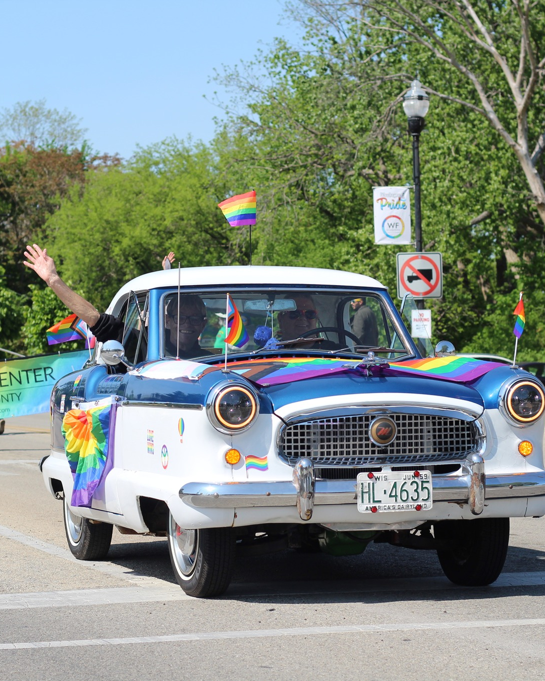 Pride parade in Waukegan with vintage car and flags