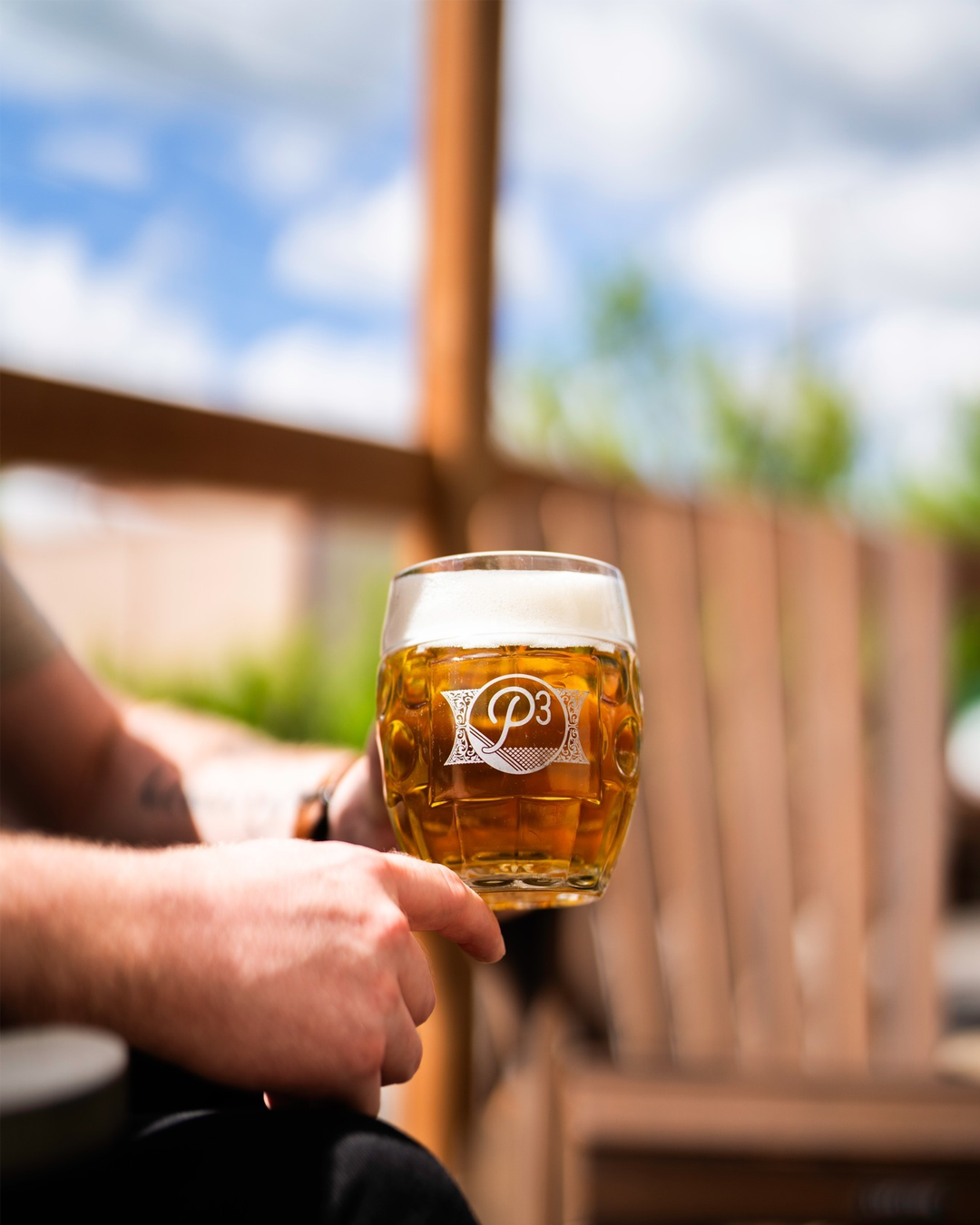 A person holding a beer at Phase Three Brewing Co in Lake Zurich