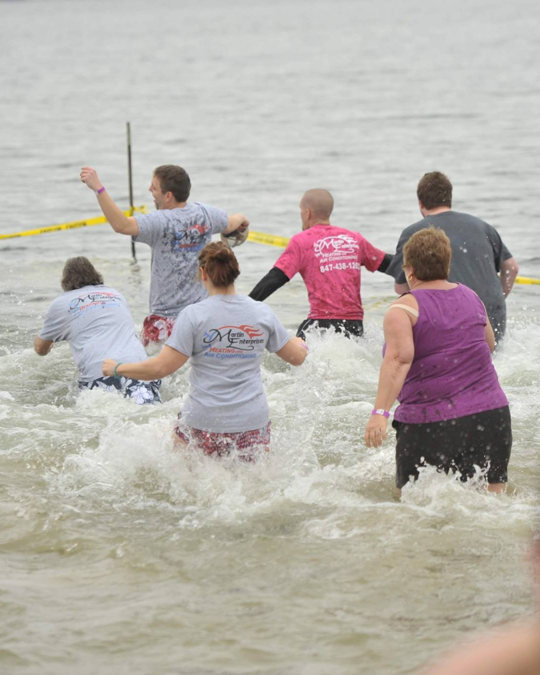 People Jumping into Lake Zurich for the Purple Plunge