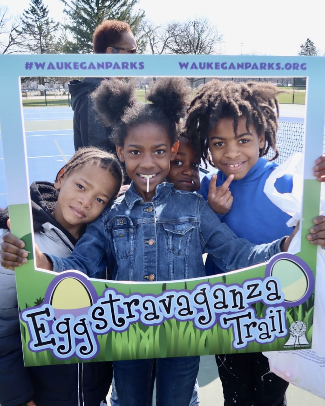Three kids posing for a picture in a photo frame